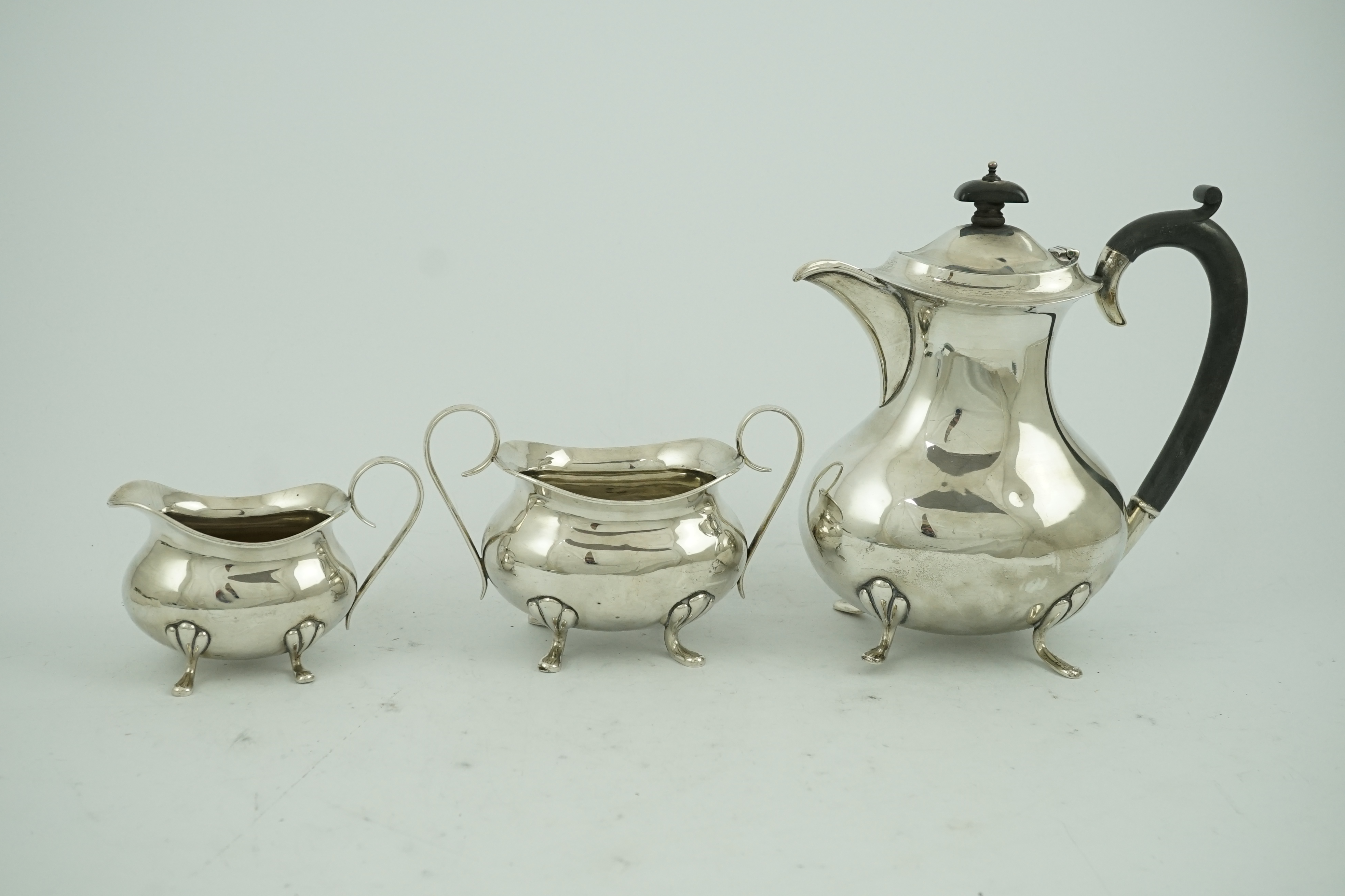 A George V matched silver three piece tea set by Joseph Gloster Ltd